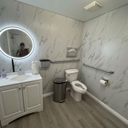 UA Construction - Commercial bathroom tile installation in the Bay Area. Full wall tile installation with large-format porcelain tiles.