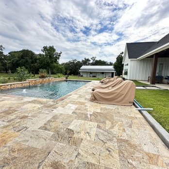 Texas Custom Outdoors - Sleek pool design in Waller County. Travertine decking. Raised wall with water features. - Pool & Hot Tub Service Near Me - Katy, Texas Texas Custom Outdoors - Sleek pool design in Waller County. Travertine decking. Raised wall with water features. - Pool & Hot Tub Service Near Me - Katy, Texas