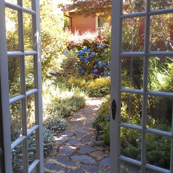 Evergreen Renovations & Roofing - a view of a garden through a door - Roofing Near Me - Portland, Oregon Evergreen Renovations & Roofing - a view of a garden through a door - Roofing Near Me - Portland, Oregon