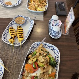 Veggie drunken noodles, chicken pad Thai, and chicken satay Veggie drunken noodles, chicken pad Thai, and chicken satay