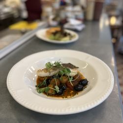 Chez Antoinette Victoria - Pan fried cod, Datterino tomatoes, pommes Parisienne, black olives & bouillabaisse