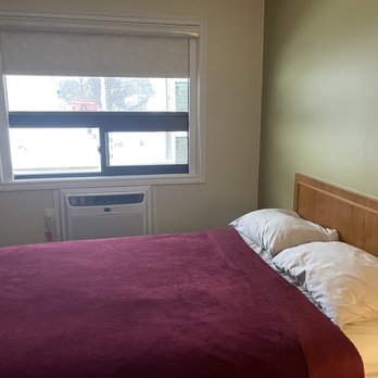 Rainbow Inn - One of the double beds with new window and A/C unit. Feels like a new mattress- which is a bonus. - Hotels Near Me - Huntsville, Ontario Rainbow Inn - One of the double beds with new window and A/C unit. Feels like a new mattress- which is a bonus. - Hotels Near Me - Huntsville, Ontario