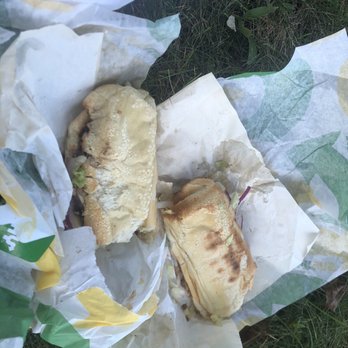Subway - a sandwich and a sandwich wrapper on the ground - Sandwiches Near Me - Waterloo, Iowa
