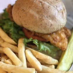 Cravins - Fish sandwich with fries and a pickle.