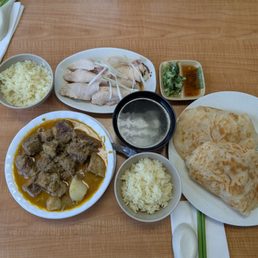 Hainanese chicken, beef brisket curry, roti Hainanese chicken, beef brisket curry, roti