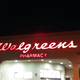 the front of a pharmacy at night the front of a pharmacy at night