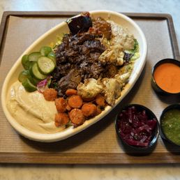 Brisket bowl w/ roasted vegetables, hummus, salad and quinoa/rice.  Healthy and full of color! Try the roasted red pepper sauce with it!