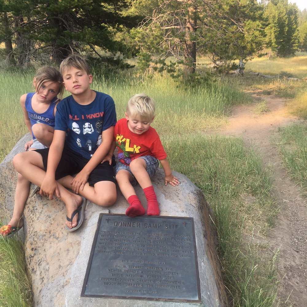 Donner Camp Picnic Ground - Kids trying to look morose at the Donner camp monument. - Hiking Near Me Donner Camp Picnic Ground - Kids trying to look morose at the Donner camp monument. - Hiking Near Me