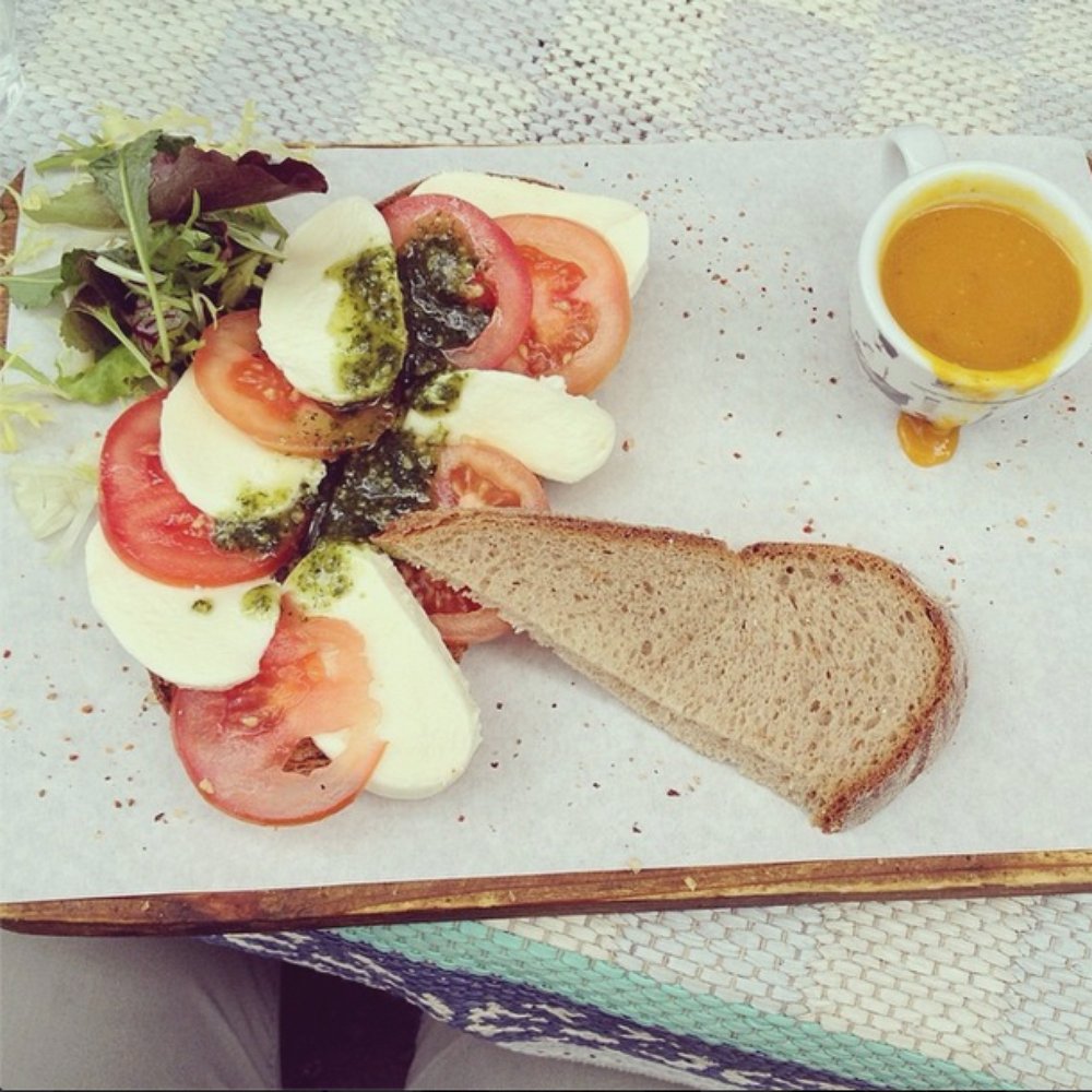 Mozzarella, tomatoes, greens, pesto on whole wheat. Yum!