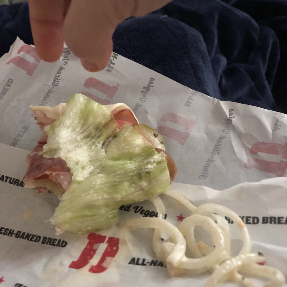 a sandwich with lettuce and onions a sandwich with lettuce and onions