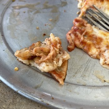 Ray's Pizza - a half eaten slice of pizza - Pizza Near Me - Glendale, Arizona