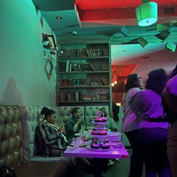 Rabbit Hole - a group of people sitting at a table - Lounges Near Me - Alhambra, California Rabbit Hole - a group of people sitting at a table - Lounges Near Me - Alhambra, California