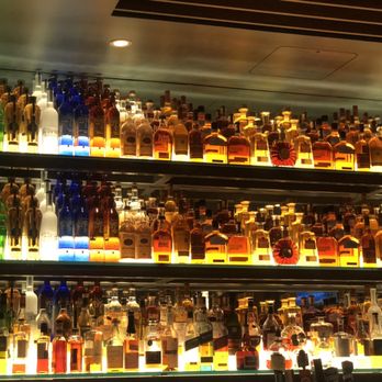 Firebirds Wood Fired Grill - Liquor on the wall behind the bar - Steakhouses Near Me - Lees Summit, Missouri