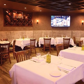 Gossip - a dining room with tables, chairs, and a flat screen tv - Adult Entertainment Near Me - Melville, New York Gossip - a dining room with tables, chairs, and a flat screen tv - Adult Entertainment Near Me - Melville, New York