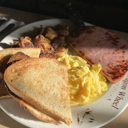 Ham steak and eggs with potatoes and sourdough toast Ham steak and eggs with potatoes and sourdough toast