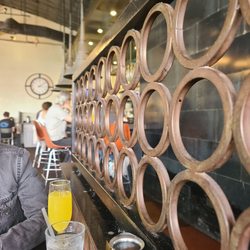 24 Diner - Cool mid-century modern decor, beautiful boyfriend's arm & his mimosa, with bar seating in the background