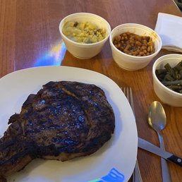 a plate of steak, beans, and a side of beans