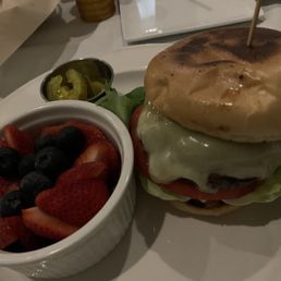 An 8oz cheeseburger and fruit. An 8oz cheeseburger and fruit.