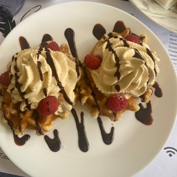 Cafe on 27 - Home made waffles with a coffee whipped cream chocolate drizzle and raspberries - Breakfast & Brunch Near Me - Topanga, California Cafe on 27 - Home made waffles with a coffee whipped cream chocolate drizzle and raspberries - Breakfast & Brunch Near Me - Topanga, California