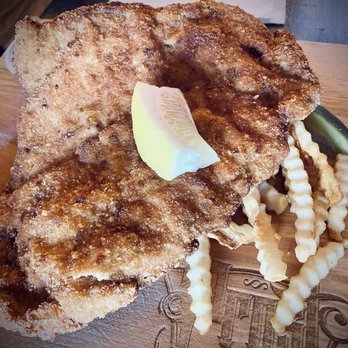 Prost Reno Biergarten - (Under German Street food) schnitzel platter: schnitzel over fries and a pickle - Beer Gardens Near Me - Reno, Nevada Prost Reno Biergarten - (Under German Street food) schnitzel platter: schnitzel over fries and a pickle - Beer Gardens Near Me - Reno, Nevada