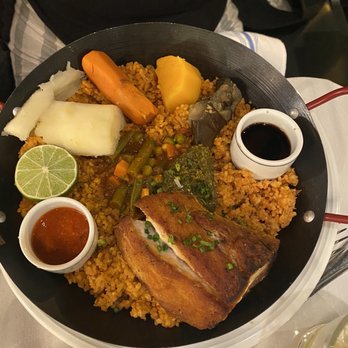 Moi Moi - Jollof rice. Really good dish and a large portion size. On the spicy side. - African Near Me - Washington, DC, District of Columbia