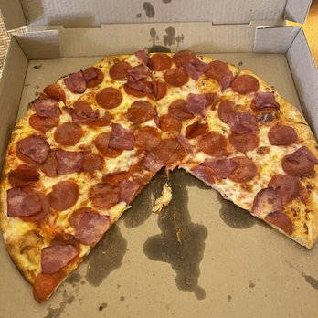 Clockwork Pizza - Pizza! - A pizza with pepperoni and ham toppings in an open cardboard box, with one slice missing and some grease stains inside. - Pizza Near Me - Tempe, Arizona