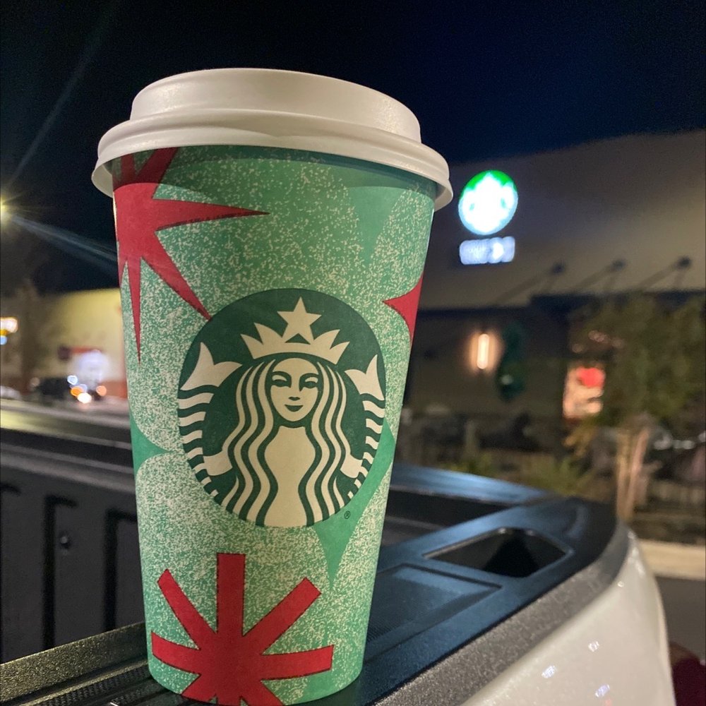 Starbucks - a starbucks cup sitting on top of a car - Coffee & Tea Near Me - Laurinburg, North Carolina