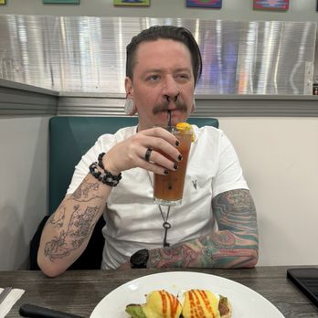 Broken Yolk Cafe - Boyfriend drinking the pomegranate sunrise - Breakfast & Brunch Near Me - La Verne, California Broken Yolk Cafe - Boyfriend drinking the pomegranate sunrise - Breakfast & Brunch Near Me - La Verne, California