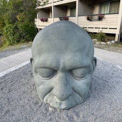 The Caen More Big Head Sculpture - Greetings and Welcome to Canmore. This is The Big Head!