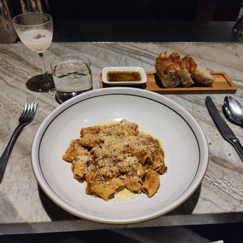 Tavernetta - Rigatoni with lamb ragu and focaccia bread with their special blend of dipping sauce - Italian Near Me - Denver, Colorado Tavernetta - Rigatoni with lamb ragu and focaccia bread with their special blend of dipping sauce - Italian Near Me - Denver, Colorado
