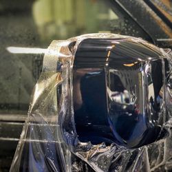 Prestige Films Window Tinting - Paint Protection Film being installed to mirrors to protect from rock chips