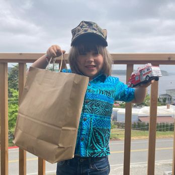 Anchorage Inn - Our son on the room's balcony, showing off the goodies he got in town. - Hotels Near Me - Coupeville, Washington Anchorage Inn - Our son on the room's balcony, showing off the goodies he got in town. - Hotels Near Me - Coupeville, Washington