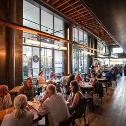 Chuckanut Bay Distillery - Dining area of Penny Farthing with view into the distillery brew space.