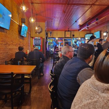 Red Brick Pub - people sitting at tables watching televisions - Sports Bars Near Me - Seneca Falls, New York