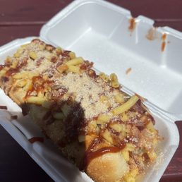 a hot dog in a styrofoam container