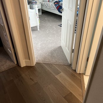 Menlo Flooring & Design - a bedroom with a bed and a dresser - Flooring Near Me - Menlo Park, California