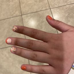Reverse French with small detailed designs of flowers on a few nails and a few nails done solid color as requested. Reverse French with small detailed designs of flowers on a few nails and a few nails done solid color as requested.