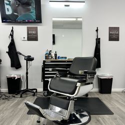Raul’s Barbershop - One of the chairs and the TV.