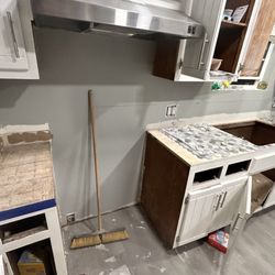 Cavins Home Solutions - Refinished cabinets tile the countertops with backsplash, new kitchen, sink, and floor