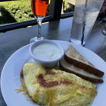 Tug's Casual Dining - Cajun Omelette  Grits / Toast  Cranberry Vanilla Mamosa - New American Near Me - Memphis, Tennessee