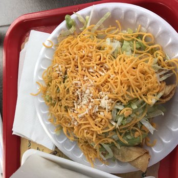 Tapatios Mexican Grill - Five rolled tacos (taquitos) smothered in lettuce, cheese, and guacamole. I know they're in there somewhere! - Mexican Near Me - Alpine, California