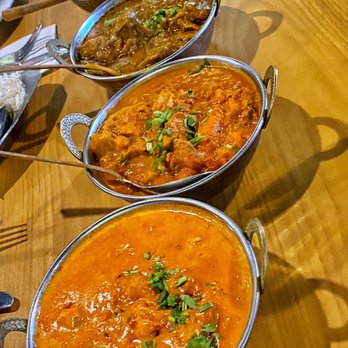 Maharaja - a variety of indian food on a wooden table - Indian Near Me - Avon, Indiana Maharaja - a variety of indian food on a wooden table - Indian Near Me - Avon, Indiana