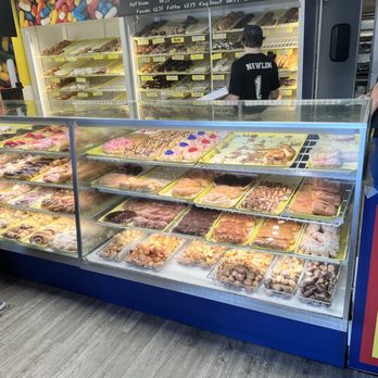 Donut King - Front case at the bottom, you can see the donut holes. They have five different types and they are all crowdpleasers! - Donuts Near Me - Minneola, Florida Donut King - Front case at the bottom, you can see the donut holes. They have five different types and they are all crowdpleasers! - Donuts Near Me - Minneola, Florida