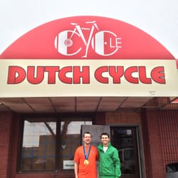 Dutch Cycle - Dutch Cycle store front with Freddy (l) and Lucas Makowsky Olympic speed skater gold medalist in green (r).