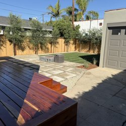 Installed the following - redwood deck - concrete pavers - grass - trees - fire pit