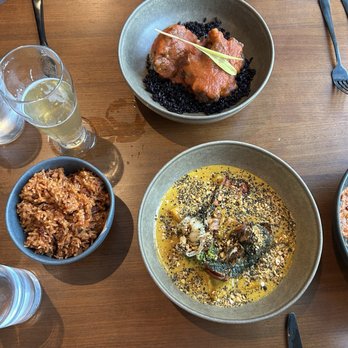 Okan - Jolloff rice, Braised Oxtails (top), and Cashew Curry - African Near Me - Bluffton, South Carolina