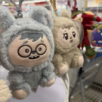 Five Below - Two plush toys dressed in animal costumes, one resembling a character with glasses and the other with a surprised expression, are displayed on a store rack. - Discount Store Near Me - Mayfield Heights, Ohio