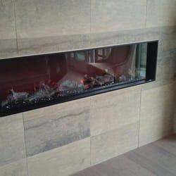 Harrison Custom Construction - Electric fireplace being installed and making sure working properly