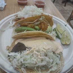 Black burned Mahi Mahi taco. I think they tried to hide it being burned by pouring excessive sauce on it.