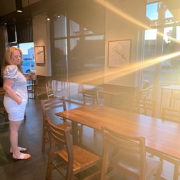 a woman standing in a coffee shop a woman standing in a coffee shop